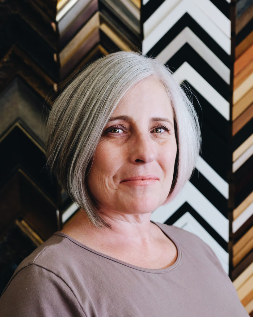 Here’s an SEO-friendly alt text for your image: Alt Text: An old lady with short hair at Framers' Workshop Of York – about Framers’ Workshop York